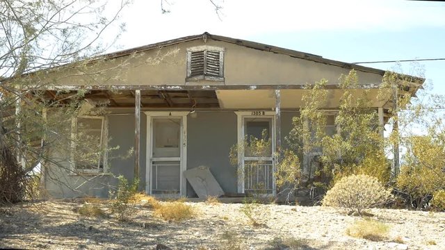 A rundown duplex building in a small town