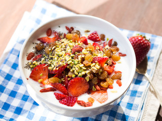 Smoothie bowl with strawberries, dried fruit and chia seeds