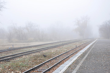 Fototapeta premium Misty landscape with railway perspective fading