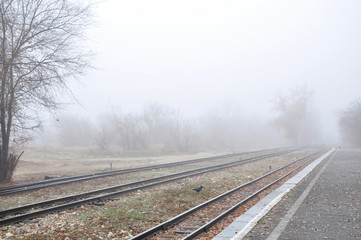 Fototapeta premium Misty landscape with railway perspective fading