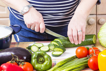 Middle age housewife cooking vegetables