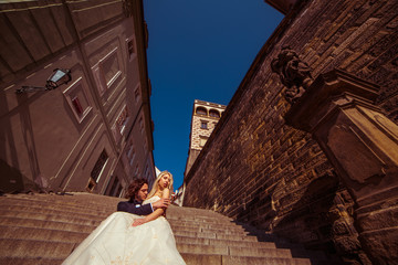 Sensual romantic newlywed couple kissing  on castle medieval sta