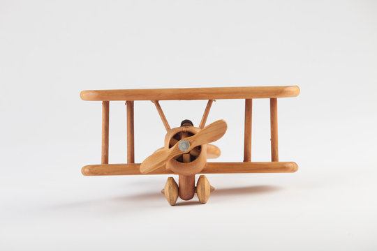 Toy wooden airplane on white background