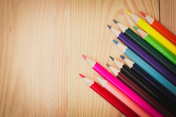 Obraz premium color pencils on wood table background vintage color tone, artist school concept.