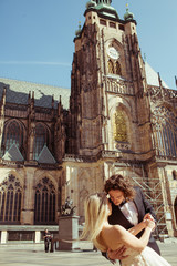Fototapeta premium Newlywed couple dancing & hugging near baroque christian cathedr