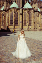 Obraz premium Beautiful blonde bride posing near baroque christian cathedral i