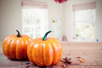 Composite image of pumpkin ornaments on desk