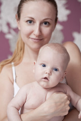 Happy mother and her little son at home