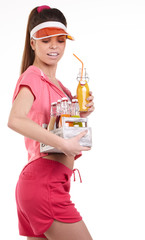 Young happy fit girl with a box of juicing cold pressed vegetabl