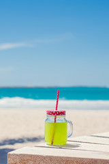 Fresh green juice on the bench near seaside area