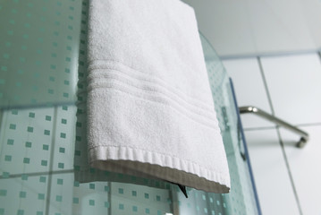 white towels hanging on shower