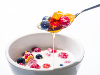 ripe raspberry and blueberry and milk on the white