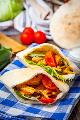 Fried chicken meat with vegetables in pita bread