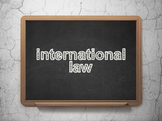 Politics concept: International Law on chalkboard background