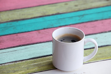 coffee cup on colorful wooden panel