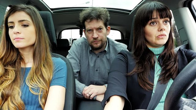 Two women and one man angry in car driving unhappy not talking 4K