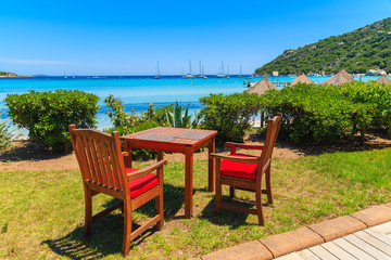 Obraz premium Chairs with table of a restaurant on Santa Giulia beach, Corsica island, France