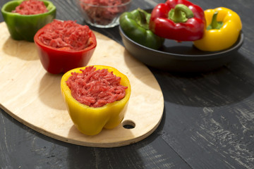 peppers stuffed with minced meat on old table