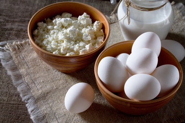Homemade dairy products and eggs on a wooden table.