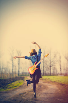 photo of young woman with guitar