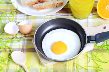 Fried egg, toast bread, fresh juice and oranges