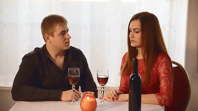 man  and girl in restaurant  rendezvous romantic Valentine's Day evening candles wine  