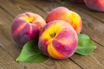 fresh peaches on wood background