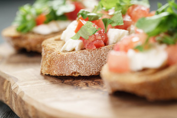 homemade bruschetta with cheese and vegetables, shallow focus