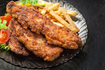 Fried fish in crispy batter with chips
