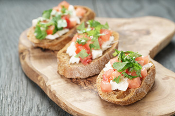 homemade bruschetta with cheese and vegetables, shallow focus