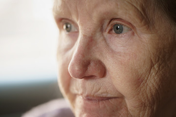 portrait of senior woman in living room, shallow focus photo