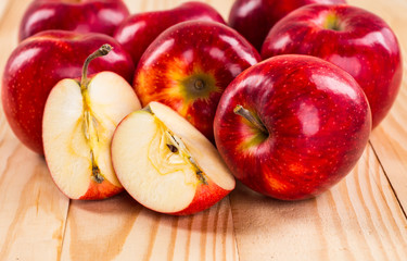 Ripe red apples on wooden background