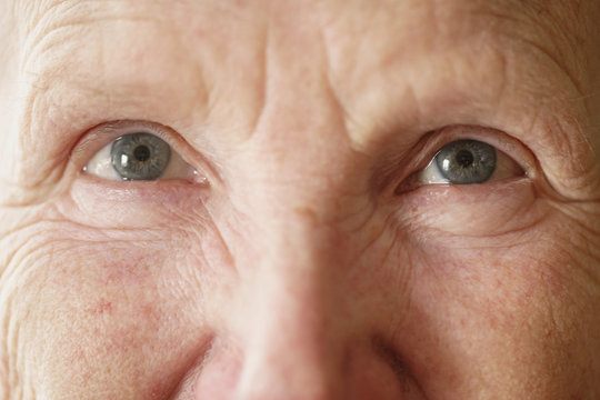 senior woman grandma eyes looking to camera close up portrait, shallow focus