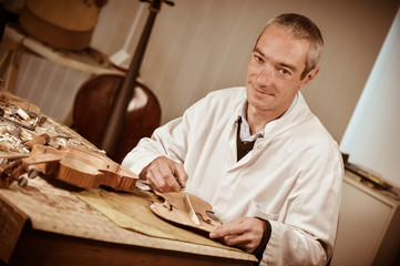 Artisan luthier working on the creation of violin.