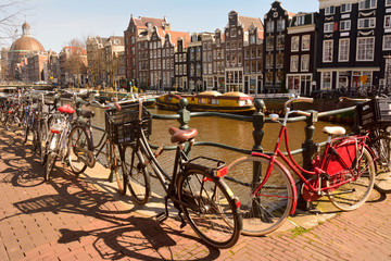 Fototapeta premium View of Singel canal in Amsterdam with bicycles in the foreground. 