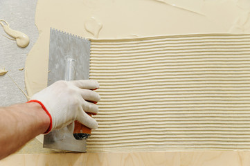 Laying plywood on the floor.