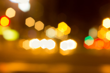 Blurry yellow evening lights as seen through abstract artistic point of view in traffic