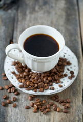 Obraz na płótnie Canvas cup of coffee on wooden surface