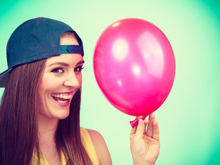 Happy teenage girl with red balloon.