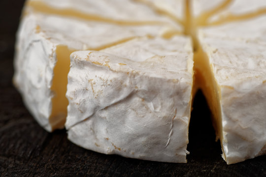 Head of brie cheese cut in pieces