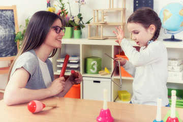 Teacher and Little Girl in Music Classroom