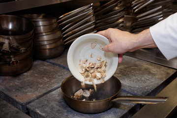 Chef is frying mushrooms