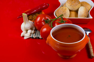 Fresh spiced tomato soup with garlic, pepper and bread