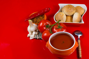 Fresh spiced tomato soup with garlic, pepper and bread