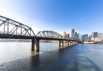 Fototapeta na wymiar steel bridge over water with cityscape and skyline in portland