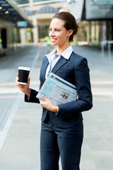 Portrait of business woman walking and smiling outdoor