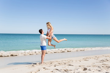 Happy couple  jumping on beach vacations