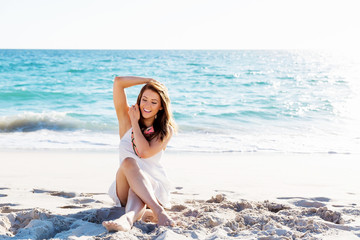 Young woman sitting on the beach