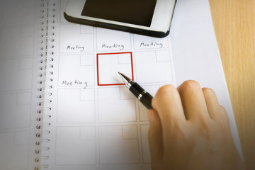 Business Meeting Schedule and Time Management - Hand Marking Calendar with Red Box  Planning and Productivity Concept Corporate Agenda and Organization Strategy