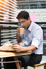 indian business male having milk tea